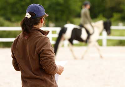 teaching horse riding at a dressage show